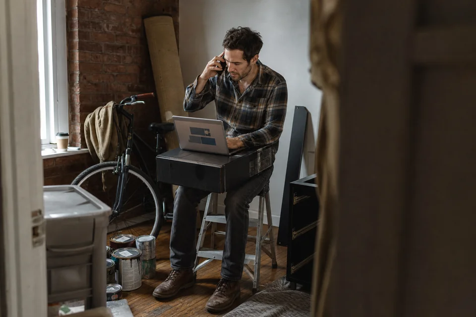 Founder of a subscription software company on a support call in his half furnished first office